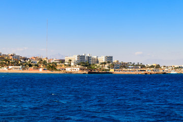 Fototapeta na wymiar Beautiful view of the coastline with houses and hotels in Hurghada, Egypt. View from Red sea