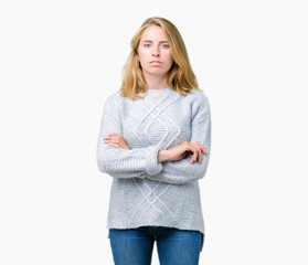 Beautiful young woman wearing winter sweater over isolated background skeptic and nervous,...