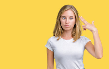 Beautiful young woman wearing casual white t-shirt over isolated background Shooting and killing...