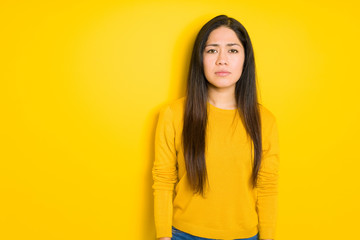 Beautiful brunette woman over yellow isolated background depressed and worry for distress, crying angry and afraid. Sad expression.