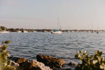 Fototapeta na wymiar Lonely Isolated Rowboat On Peaceful Calm Water Ocean Bay 