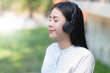 Asia woman using smartphone,listening to music with relax fun and happy in free time .