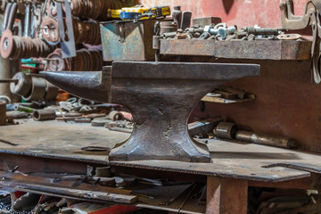 Old anvil on steel table