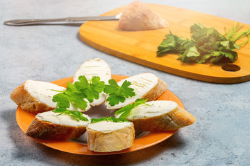 Freshly made Sandwiches with cream cheese on a plate on a gray table