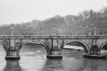 Ponte Sant'Angelo and the Tiber River in the snow, in Rome, Italy