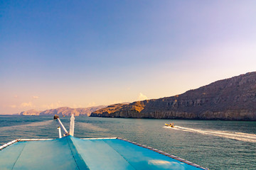 Sea, pleasure boats, rocky shores in the fjords of the Gulf of Oman