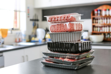 meat sitting on a kitchen bench in plastic packaging form the supermarket, grocery store