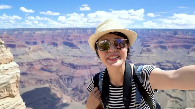 fast forward female backpacker sightseeing amazing nature desert view in Grand Canyon national park arizona usa. tourist in sunglasses online video phone call telling friends to come travel with her.