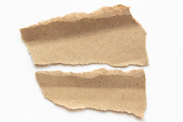 Brown corrugated texture paper torn on white background. rip of cardboard sheet used as a...