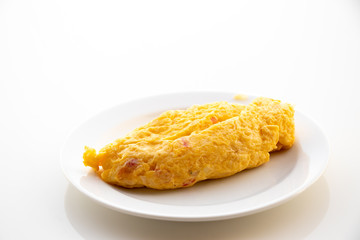 Egg omlet in dish place on white table background