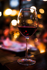 bokeh night glass of red wine valentines day