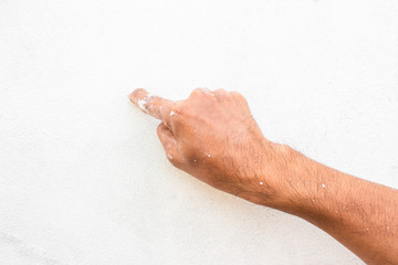 Fototapeta premium Hand stain of color on the white wall background.