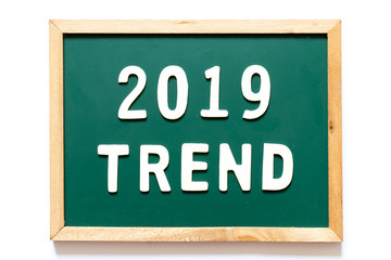 Green blackboard and wood frame with word 2019 trend on white background