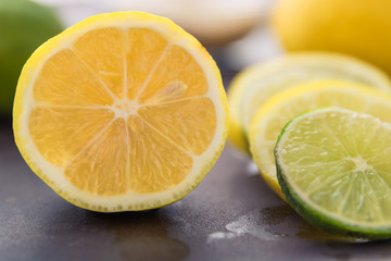 A Juicy Lemon Half with Lemon and Lime Slices - Close Up