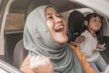 Fototapeta premium Muslim Lady Dancing Happily in Her Car