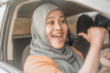 Muslim Lady Dancing Happily in Her Car