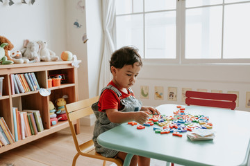 Young kid playing with educational toys