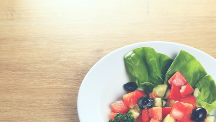 vegetable salad on white plate  wooden background