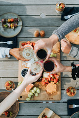 Friends cheering with glasses of wine