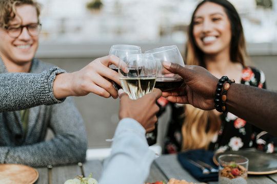 Friends Toasting At A Rooftop Party