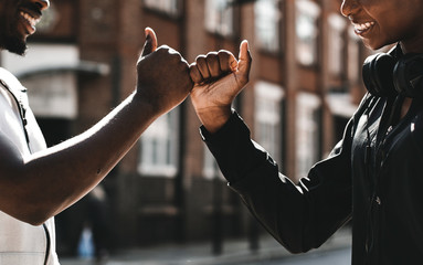 Friends greeting with a signature handshake