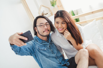 Fototapeta na wymiar Young Asian couple lover, take a photo by selfie in bedroom, Asian couple lover Valentine concept