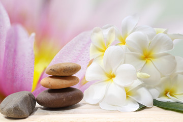 Zen spa concept background - Zen massage stones with frangipani plumeria flower