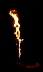 Burning fire stick in mans arm, cane in flame isolated on black