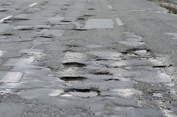 Poor condition of the road surface. Winter season. Wet and foggy weather. Residential area of Kiev. 