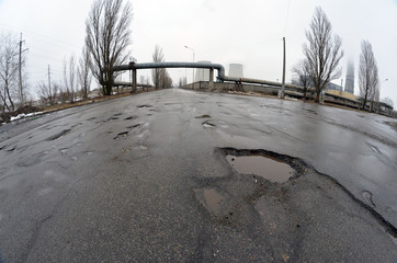 Poor condition of the road surface. Winter season. Wet and foggy weather. Residential area of Kiev. 