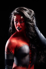 sexy asian woman with long black hair wearing fantasy red and black devil body paint costume