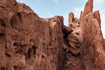 Cyclist riding a mountain bike downhill style in a canyon 