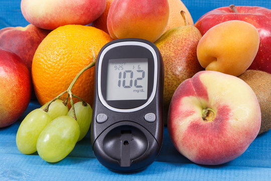 Glucose meter for measuring sugar level and healthy food as source vitamins, diabetes concept