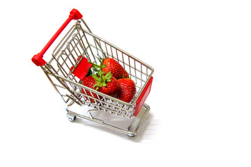 Fresh strawberries in shopping cart on white background.