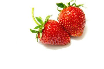 Two strawberries close up on white background