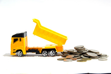 Toy lorry with coins on white background, Business concept.