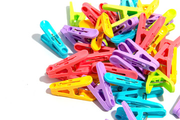 Colorful wood clothespins pegs on white background.