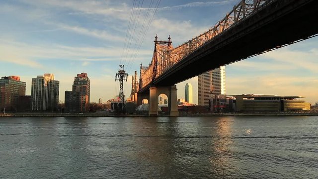 Timelapse from east river with view on Queensboro bridge and tram at sunset