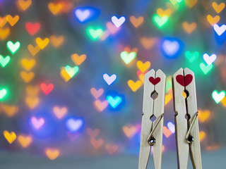 Closeup, cute wooden clothespin with red heart shape On a beautiful heart-shaped bokeh background For valentine