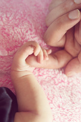Obraz na płótnie Canvas Sweet Newborn Baby Girl Hand Holding Daddy