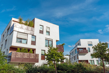 Modern white apartment houses with a blue sky seen in Berlin, Germany