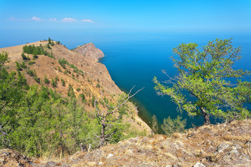 Fototapeta na wymiar Baikal Lake in June. The northern edge of the Olkhon island and the famous Cape Khoboy - a natural landmark. Trips, excursions and hikes around the island in summer