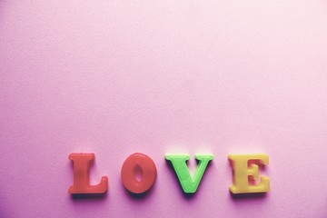 'love' word Close-up shot with a selective focus of the colorful magnetic letters for Valentine's Day