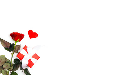 Gift box, rose flower and decorative hearts on white background. Place for text, top down composition.