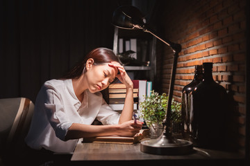 Young Asian business woman working over time at night, work hard, tried, stress concept