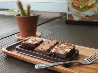 sliced homemade brownies on wood plate