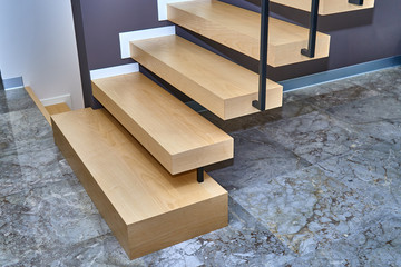 Ash wooden staircase with black fencing in the style of minimalism