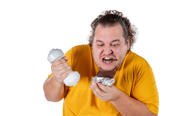 Funny fat man eating unhealthy food and trying to take exercise isolated on white background