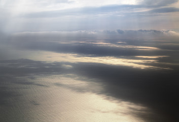 sun's rays illuminate the surface of the sea through the clouds