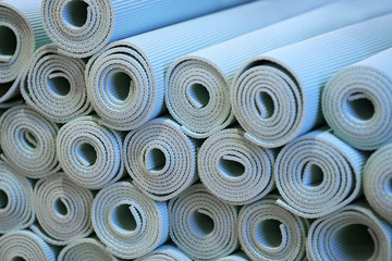 Blue Foam Yoga Mats Rolled up on Display at Gym